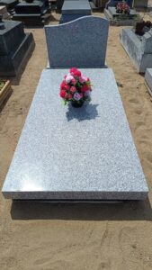 Tombe avec fleurs colorées.